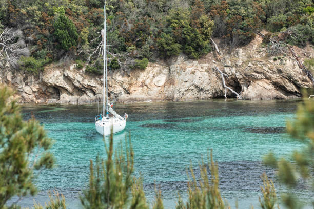 Cove and sailing boat in the island of Porquerolles in the Var, in Provence, on the Côte d'Azur stock photo