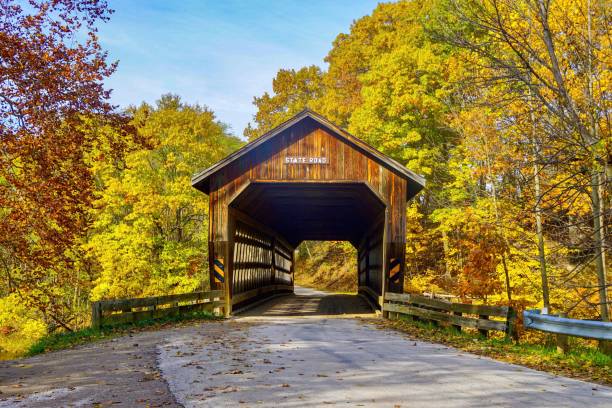 Covered bridge on an autumn day Covered bridge on a country road in Ohio covered bridge stock pictures, royalty-free photos & images