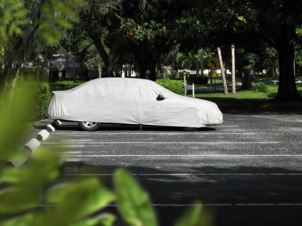 Covered car in parking lot stock photo