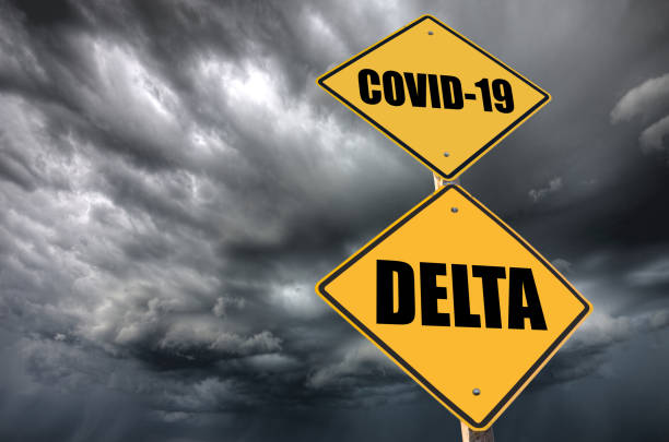 Covid Delta Variant warning sign with dark sky stock photo