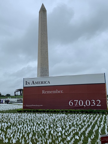 September 17, 2021.  Washington, DC. A Covid-19 memorial commemorating those that died on the National Mall in front of the washington Monument in Washington DC on an overcast day.