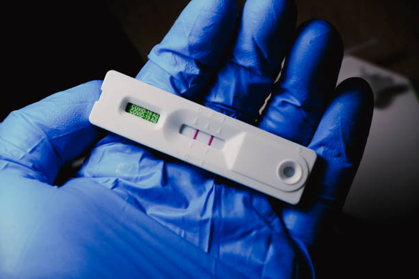 Covid-19 positive result cassette from a rapid antigen test kit stock photo