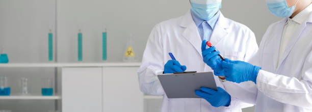 Covid-19 testing in laboratory. Closeup Scientists hand with blood samples of patients infected with Coronavirus disease 2019. Healthcare and medical concept. stock photo