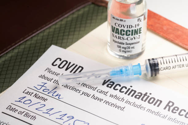 Covid-19 vaccination record card with syringe and vial  covid vaccine stock pictures, royalty-free photos & images