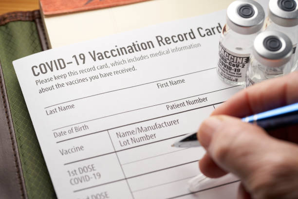 Covid-19 vaccination record card with vials and syringe. Covid-19 vaccination record card with vials and syringe. cdc vaccine card stock pictures, royalty-free photos & images