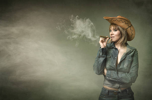 cow-girl-smokes-big-cigar-picture-id471893938