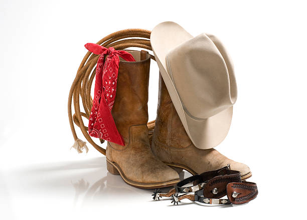 Cowboy accessories, hat,boots,spur,rope,bandana-isolated on white Basics needed for wranglers in the wild west.255 white background. cowboy boot stock pictures, royalty-free photos & images