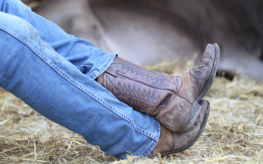 Cowboy Leather Boots And Pants In Blue Jeans Stock Photo - Download ...