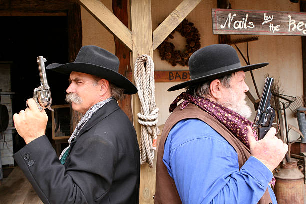 Cowboys prepping for a gun duel stock photo