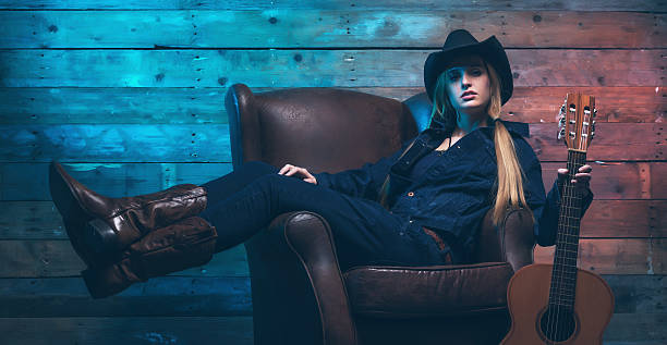 Cowgirl country singer with acoustic guitar. stock photo
