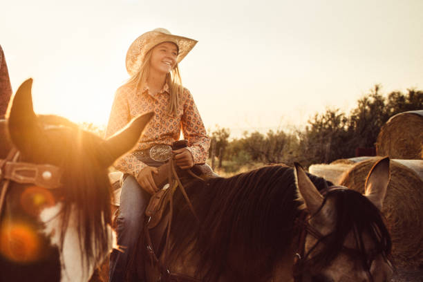 Cowgirl Horseback Riding Cowgirl Horseback Riding in Utah at Sunset westlife stock pictures, royalty-free photos & images