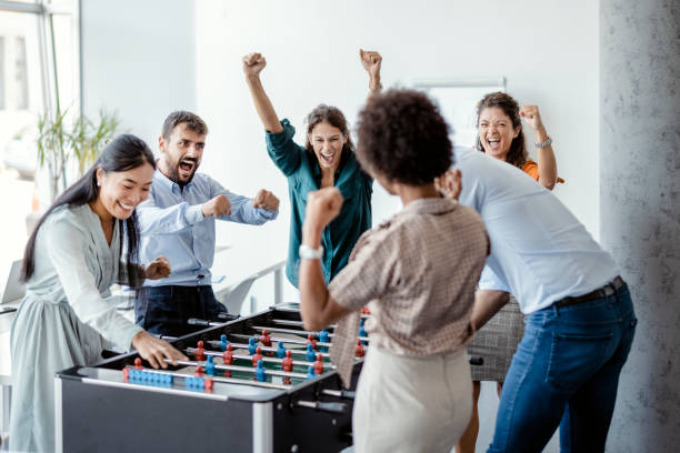 Coworkers Playing Table Football stock photo