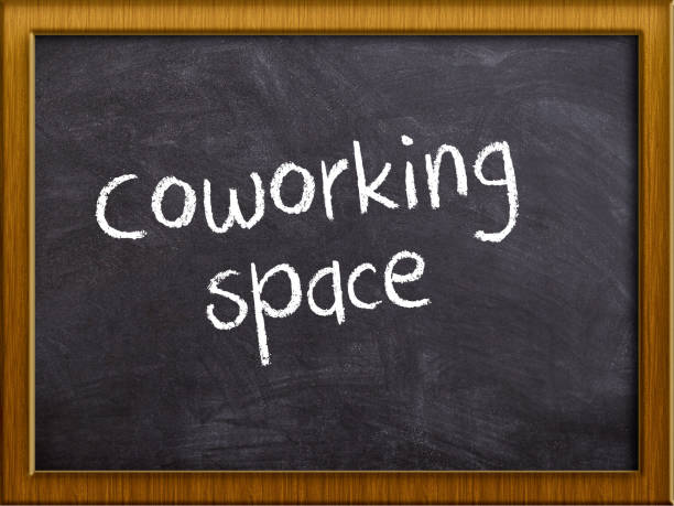 Coworking space writed on a blackboard with frame stock photo