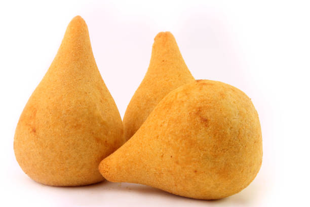 Coxinha, traditional Brazilian cuisine snacks stuffed with chicken, isolated on white background. Close up stock photo