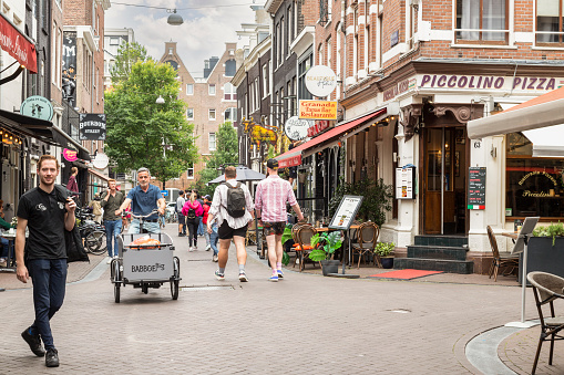 Amsterdam, Netherlands, July 10, 2022; Cozy street for tourists and residents in the center of Amsterdam.