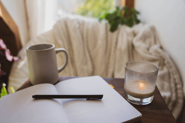Cozy Window Nook with Open Journal And Coffee stock photo