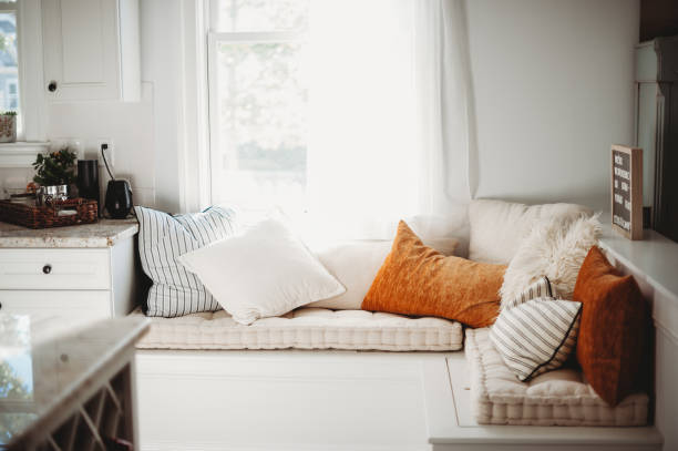 Cozy window seat A fun and cozy window seat bathing in the morning sun alcove window seat stock pictures, royalty-free photos & images