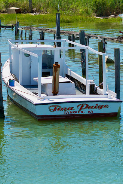 Crabbing Boat, Tangier Island, Virginia Tangier Island, Virginia / USA - June 21, 2020: The “Tina Paige” is one of many boats used by watermen in this popular tourist destination in the Chesapeake Bay. tangier island stock pictures, royalty-free photos & images