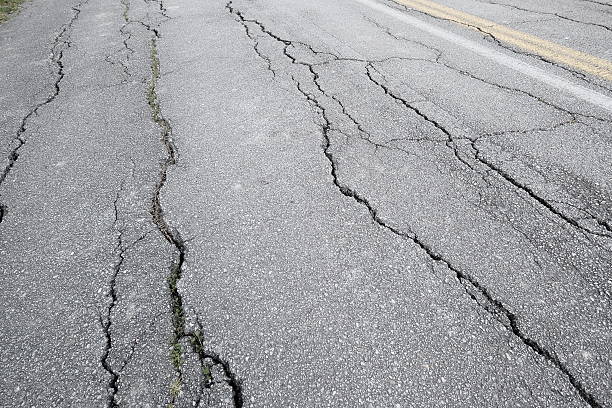 Cracked road surface - asphalt in bad conditions stock photo