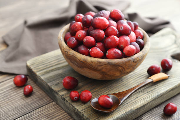 Cranberries in wooden bowl stock photo