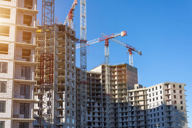 Crane and building construction site, look up view. Crane and building construction site, look up view Condominium under construction stock pictures, royalty-free photos & images
