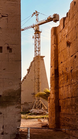 Crane in ancient Egyptian ruins, Luxor, Egypt