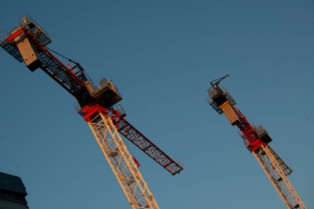 2 cranes against the sky stock photo