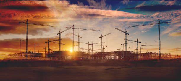 Cranes and building construction Construction and real estate industry. Sunset and foundation structure of houses. construction site stock pictures, royalty-free photos & images