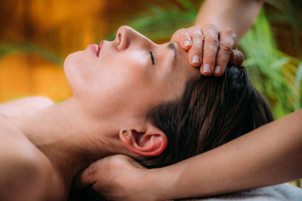 Craniosacral Therapy Massage. Therapist Massaging Woman’s Forehead. stock photo