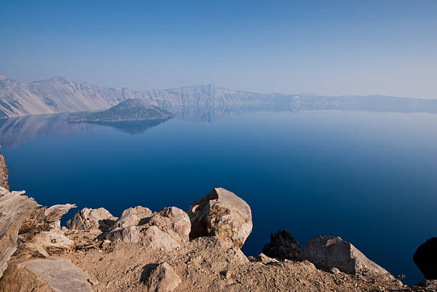 Crater Lake in the Early Morning Crater Lake exists in the blown-out caldera of a once mighty volcano known as Mount Mazama. This view of the lake and Wizard Island was taken from the Garfield Peak Trail in Crater Lake National Park, Oregon, USA. jeff goulden crater lake national park stock pictures, royalty-free photos & images