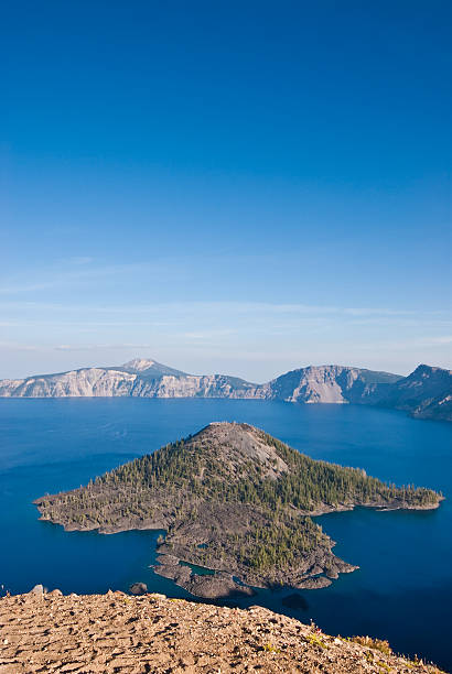 Wizard Island and Crater Lake Crater Lake exists in the blown-out caldera of a once mighty volcano known as Mount Mazama. This view of the lake and Wizard Island was taken from Watchman Overlook in Crater Lake National Park, Oregon, USA. jeff goulden crater lake national park stock pictures, royalty-free photos & images