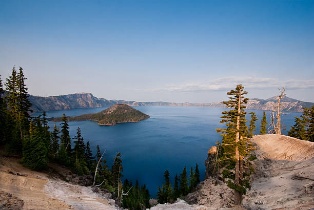 Crater Lake and Wizard Island Crater Lake exists in the blown-out caldera of a once mighty volcano known as Mount Mazama. This view of the lake and Wizard Island was taken from Discovery Point in Crater Lake National Park, Oregon, USA. jeff goulden crater lake national park stock pictures, royalty-free photos & images