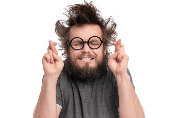 Crazy bearded man emotions and signs Crazy Bearded happy Man with funny Haircut in Eyeglasses making Luck gesture. Cheerful and silly guy crossing his fingers, isolated on white background. prayer request stock pictures, royalty-free photos & images