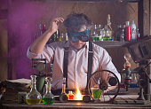 crazy medieval scientist working in his laboratory