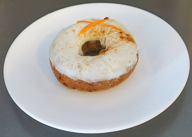 A Cream Cheese Iced Carrot Cake Doughnut stock photo