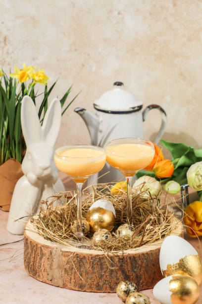 Creamy advocaat egg liqueur drink for Easter celebration in springtime with tulips Creamy advocaat egg liqueur drink for Easter celebration in springtime with tulips easter sunday stock pictures, royalty-free photos & images