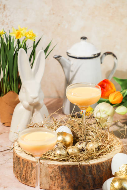 Creamy advocaat egg liqueur drink for Easter celebration in springtime with tulips Creamy advocaat egg liqueur drink for Easter celebration in springtime with tulips easter sunday stock pictures, royalty-free photos & images