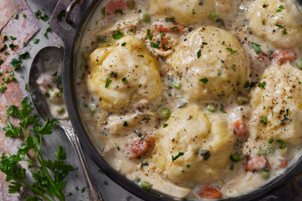 Creamy Chicken and Dumplings Creamy Chicken and Dumplings with Roast Chicken, Green Peas, Celery and Carrots casserole dish stock pictures, royalty-free photos & images