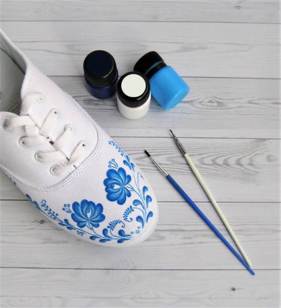 Create a fashionable design painting white sneakers stock photo