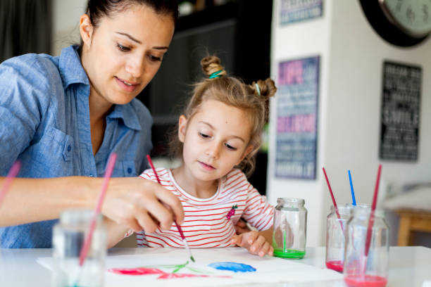 creative activity mother and daughter drawing together tempera painting stock pictures, royalty-free photos & images