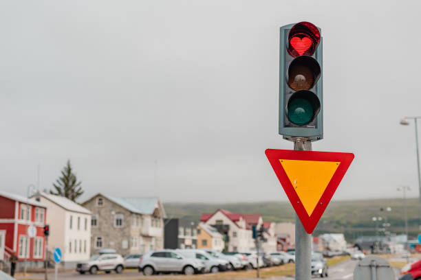 Creative heart shaped traffic light. Red light displaying heart symbol in Akureyri, Iceland. A cool and welcoming thing for motorist standing in the queue. stock photo