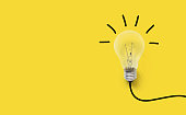 istock Creative thinking ideas brain innovation concept. Light bulb on yellow background 950216224