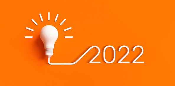 2022 Creativity and inspiration ideas with lightbulb on color background.Business solution or smart working concepts