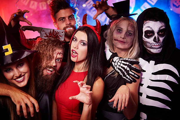 creepy faces made by party people - kostuum stockfoto's en -beelden