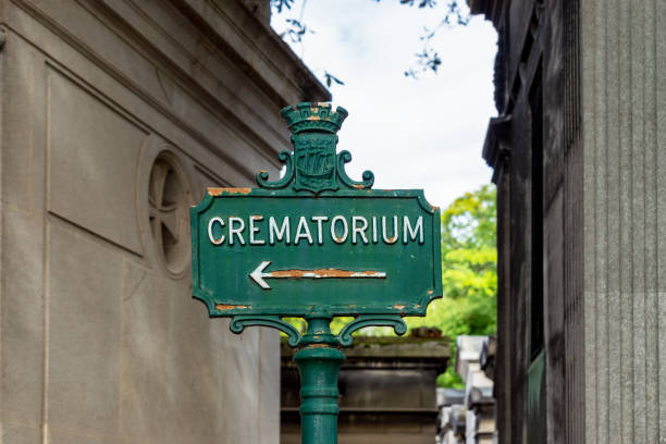 Crematorium sign in Pere Lachaise Cemetery - Paris, France Paris, France - September 11 2019: Rusty Crematorium sign in Pere Lachaise Cemetery - Paris, France. cremation stock pictures, royalty-free photos & images