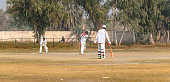 istock cricket players in action on match ground 1393792002