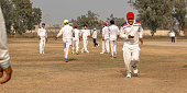 istock cricket team players on match ground 1393792018