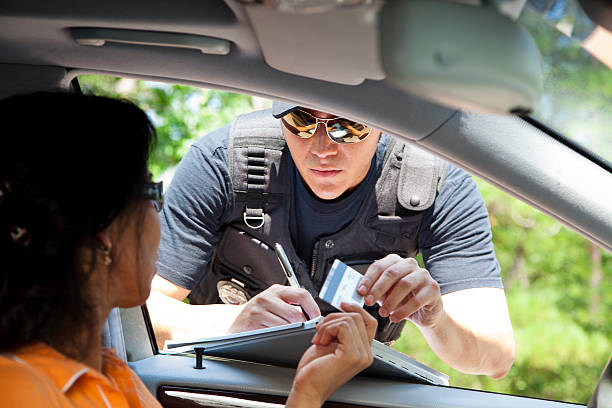 Crime: Policeman gives driver a traffic ticket. stock photo