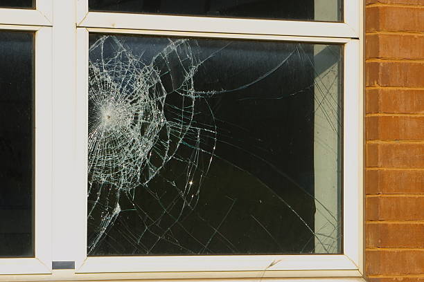Crime scene Close up of a broken window, shatterproof glass. broken stock pictures, royalty-free photos & images