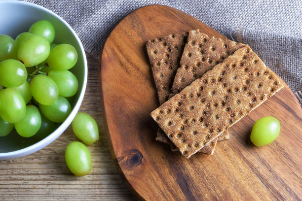 Crisp bread and grapes on the table closeup stock photo